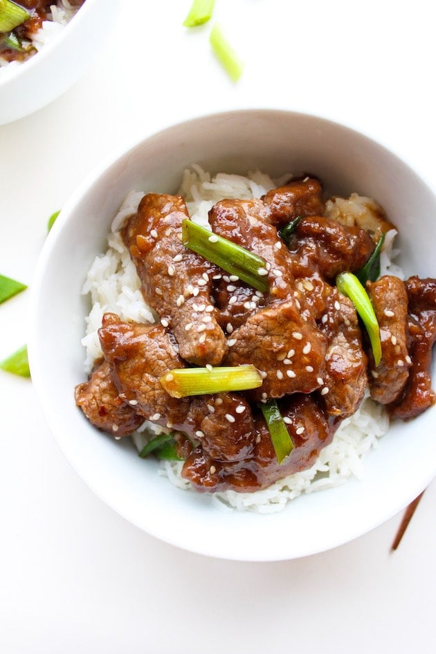 Paleo Mongolian Beef in a bowl topped with spring onions