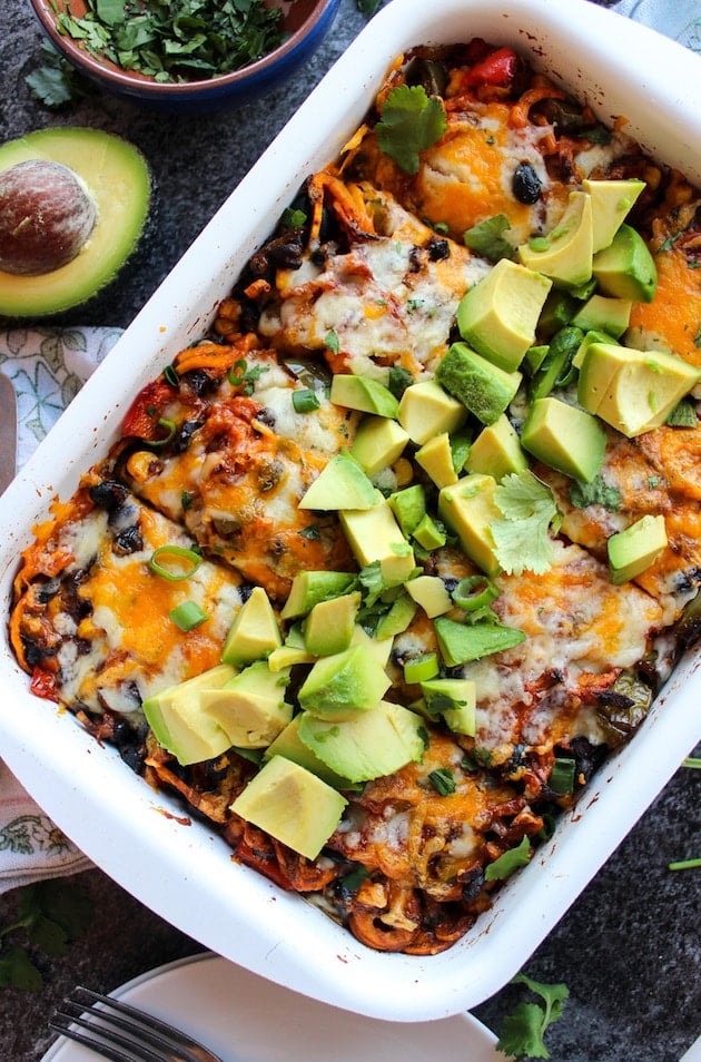 Spiralized Sweet Potato Enchilada Casserole topped with cubed avocado, fresh cilantro and spring onions