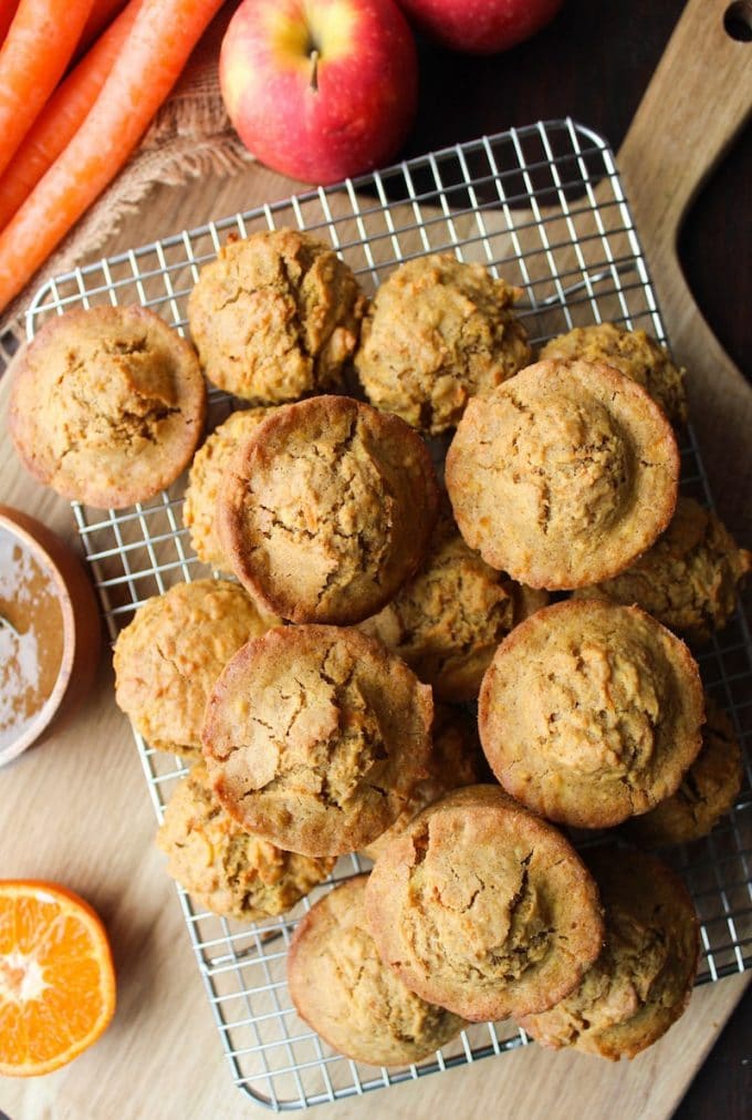 a couple dozen Carrot Apple Muffins piled on a wire cooling rack 