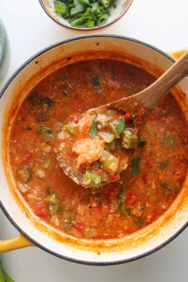 One pot Fast Seafood Gumbo with a soup ladle holding up gumbo 