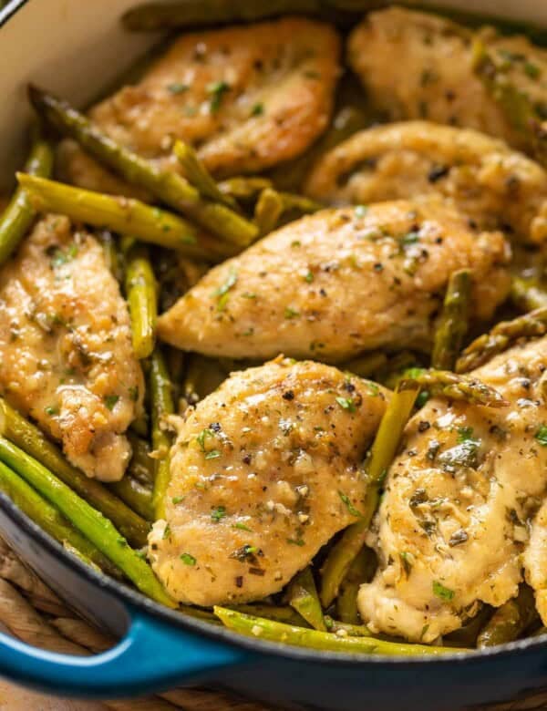 Lemon Chicken with Asparagus in a pan with fresh parsley