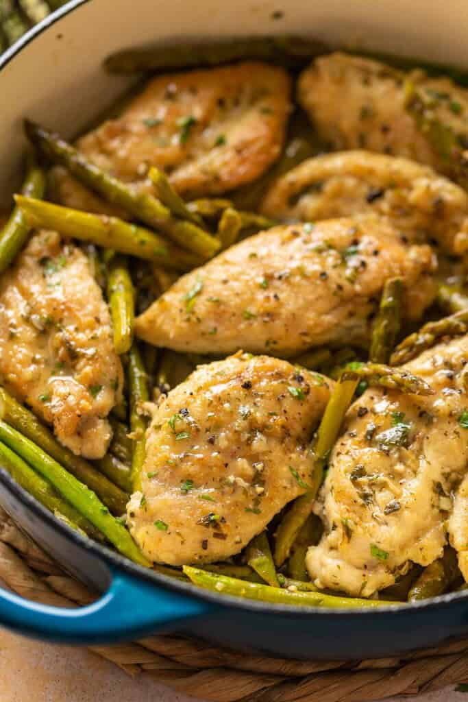 Lemon Chicken with Asparagus in a pan with fresh parsley