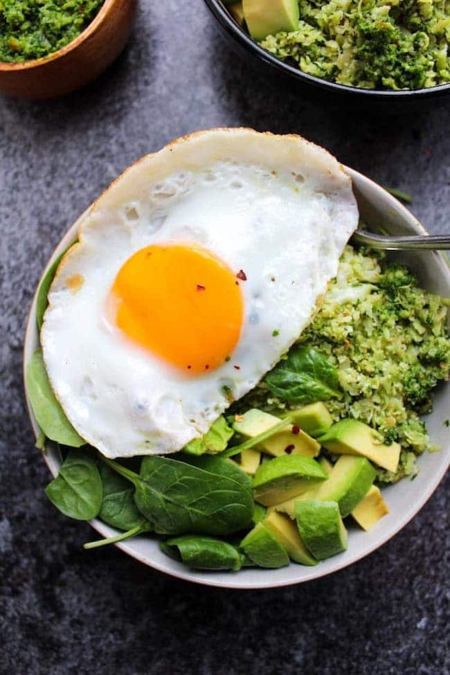 Pesto Cauliflower Rice Bowls topped with an egg and avocado