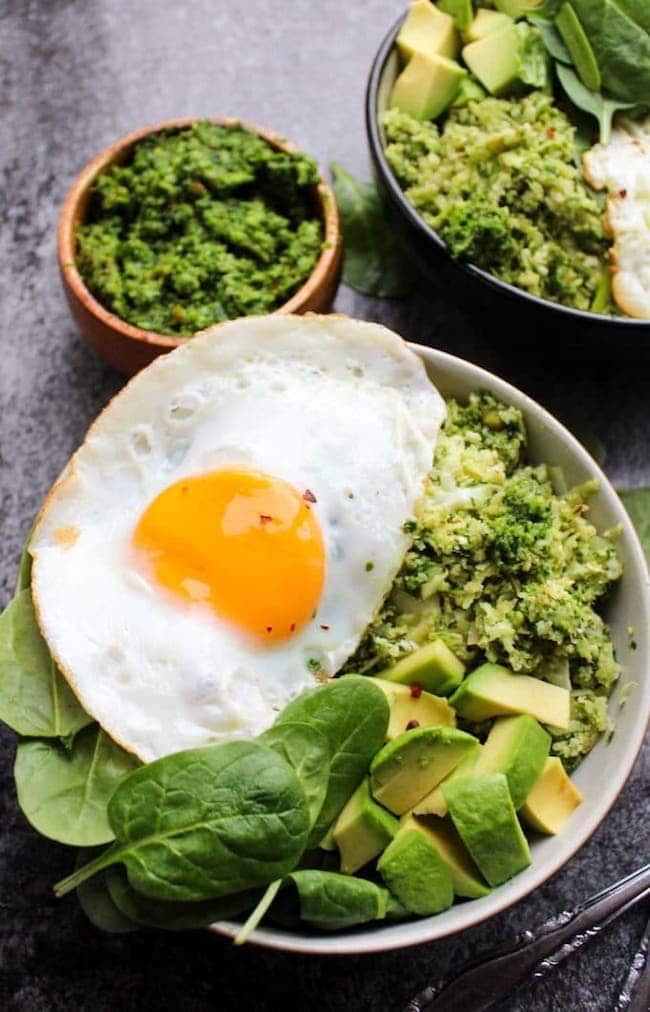 Pesto Cauliflower Rice Bowls topped with eggs and avocado