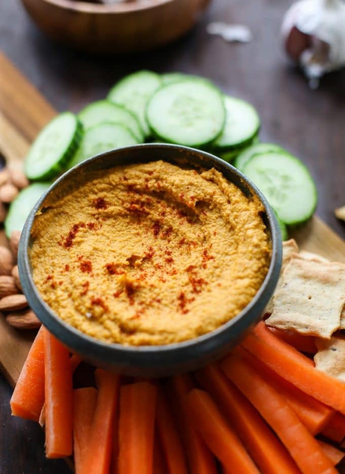 roasted carrot hummus in a dipping bowl topped with paprika 