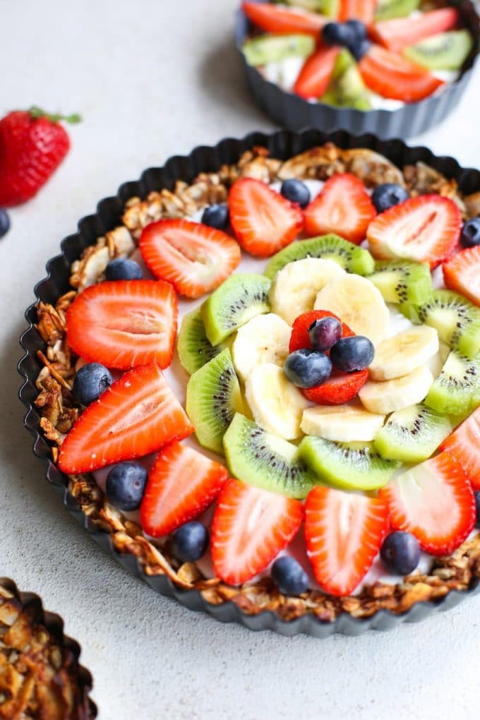 Fruity Granola Breakfast Pizza - a grain free nut & coconut crust that's naturally sweetened with a coconut cream top and fresh fruit | Paleo + Vegan + Gluten Free