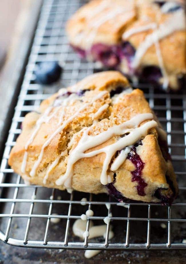 Vegan Gluten Free Blueberry Scones with a simple maple glaze on a cooling rack