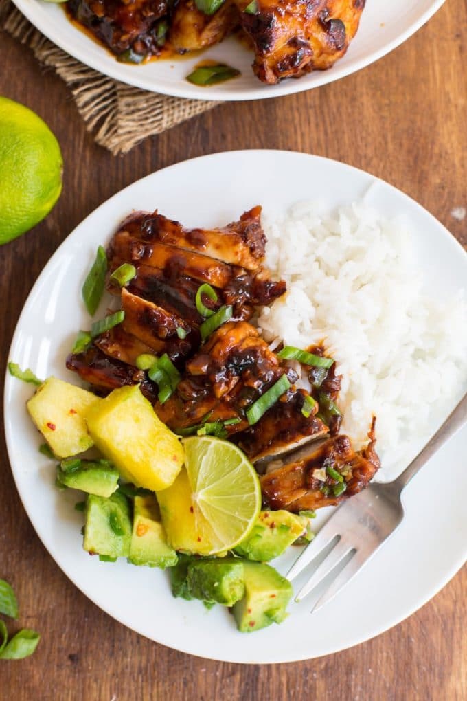 a plate of Honey Siracha Chicken with a Pineapple Avocado Salsa on the side