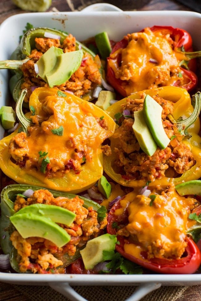 taco stuffed peppers - some topped with cheese 