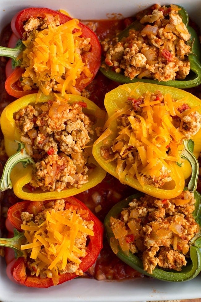 taco stuffed peppers in a baking dish before cooked 