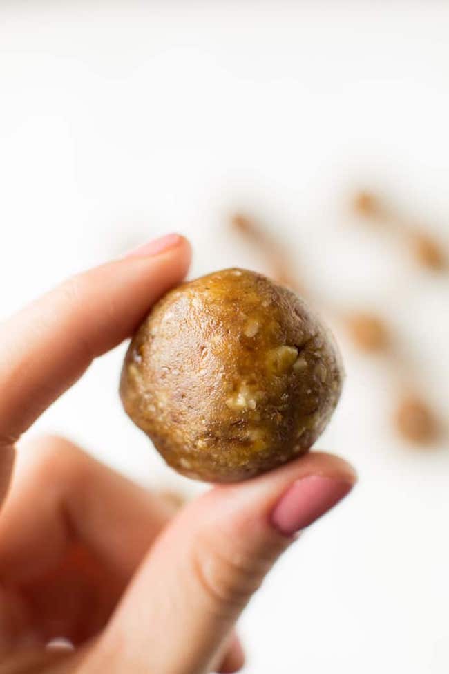 hand holding one of the nut date balls