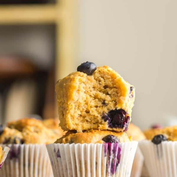 two Gluten Free Blueberry Cornbread Muffins stacked on a cooling rack