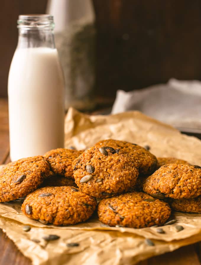 a pile of Sweet Potato Breakfast Cookies with a jar of milk