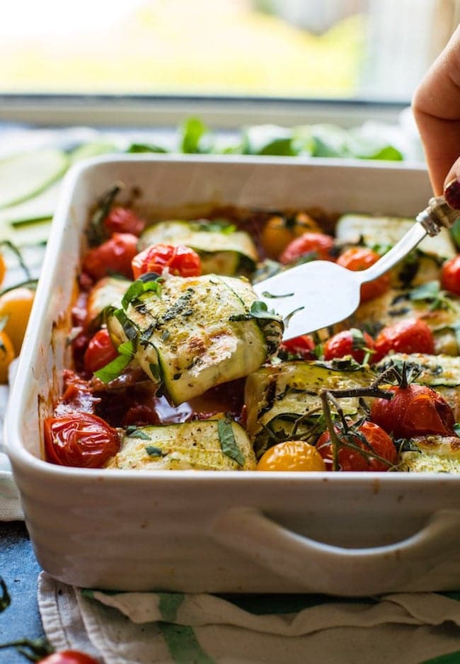 zucchini ravioli lifted up on a serving spoon