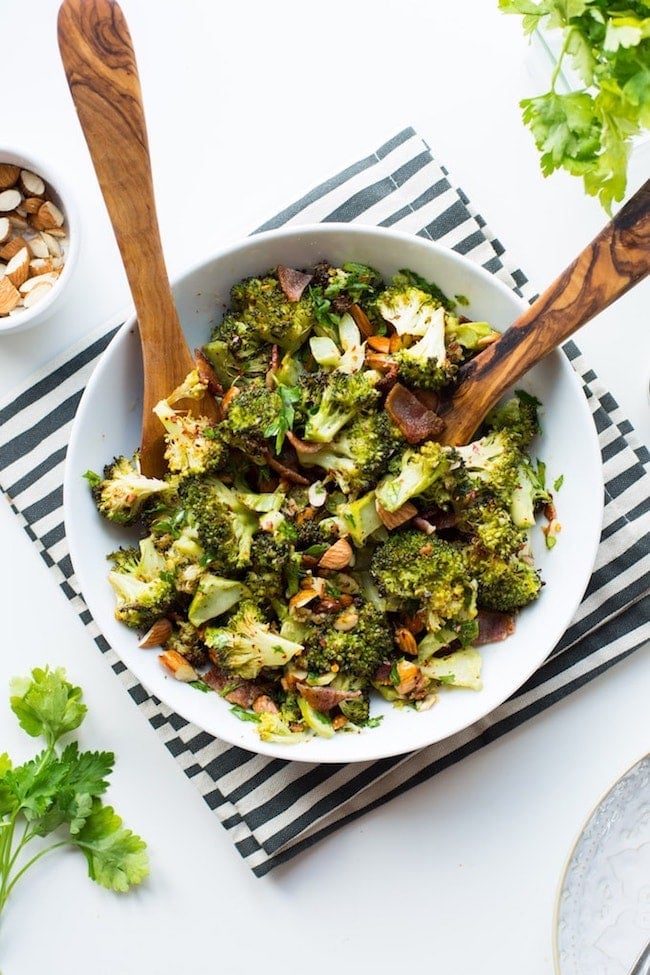 Garlic & Chili Roasted Broccoli Salad in a bowl with salad tongs