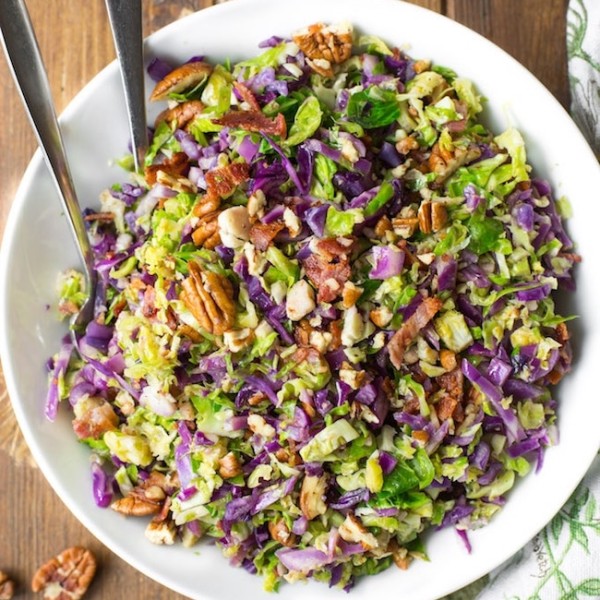 Bacon Brussels & Cabbage Salad in a serving bowl with tongs