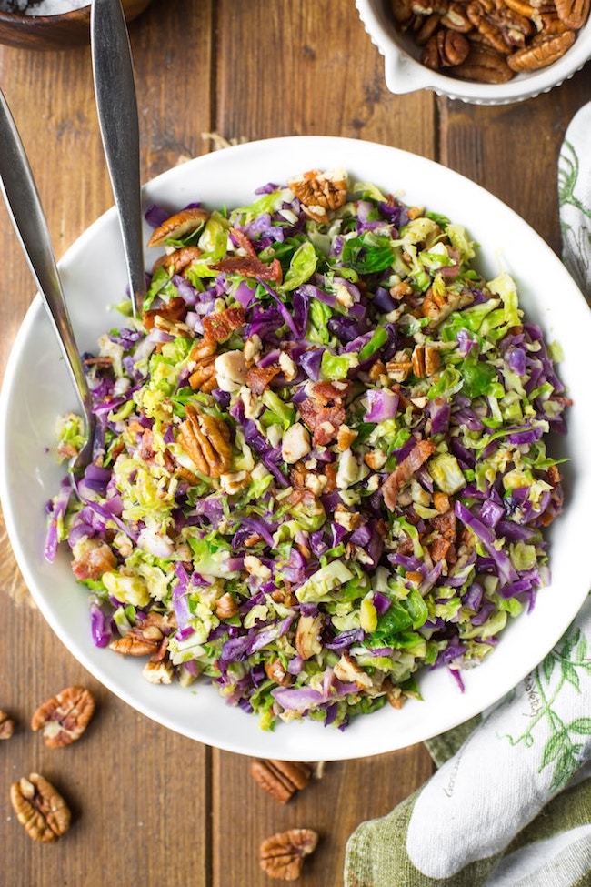 Bacon Brussels & Cabbage Salad in a serving bowl with tongs