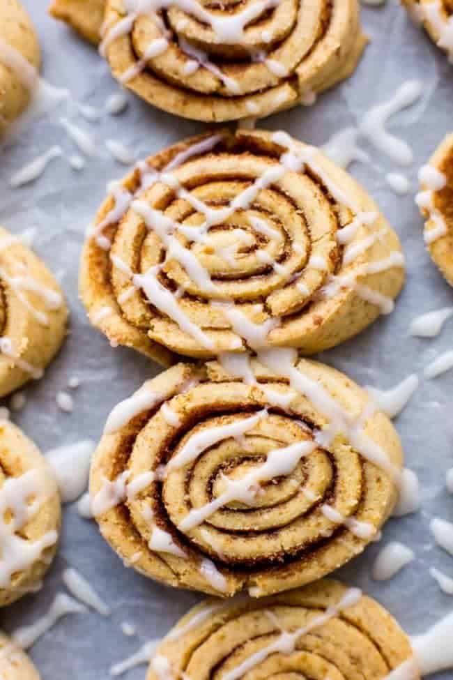  Gain Free Cinnamon Roll Cookies drizzled with icing on a baking tray