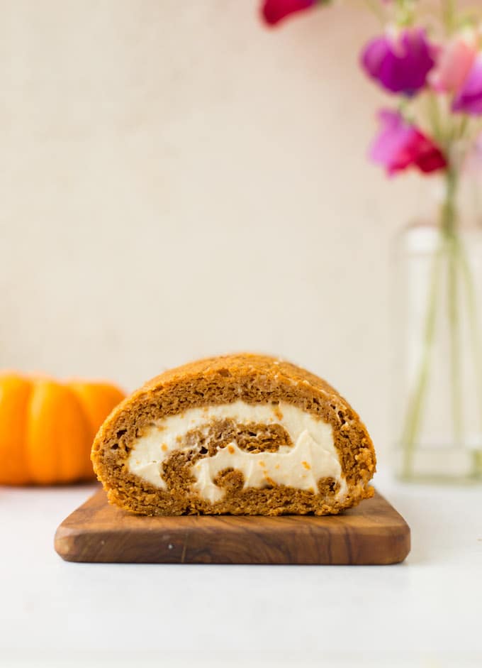 Tender, moist and flavourful Paleo Pumpkin Roll - a light and fluffy almond based cake filled with a simple cashew cream! | Gluten Free + Dairy Free | Front view of cake