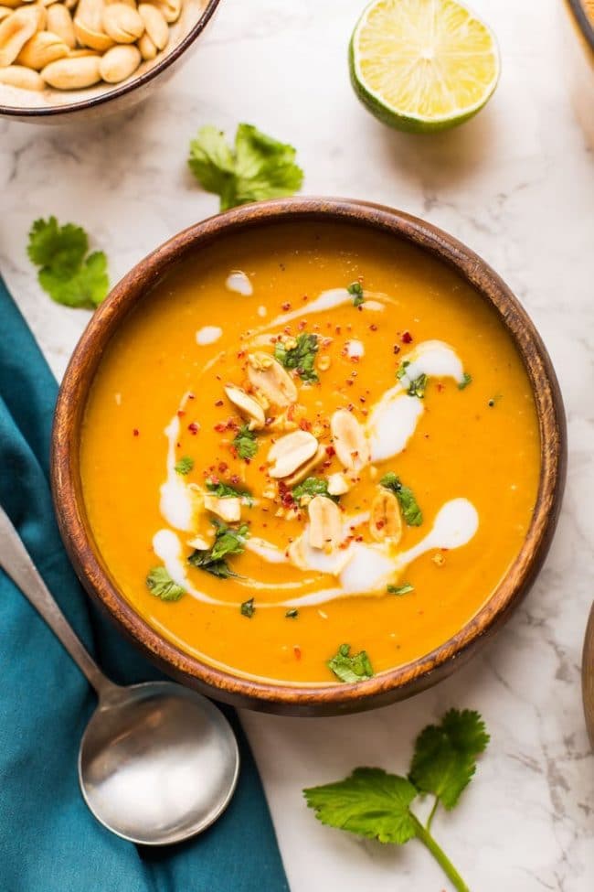 Peanut Carrot & Sweet Potato Soup in a wooden bowl