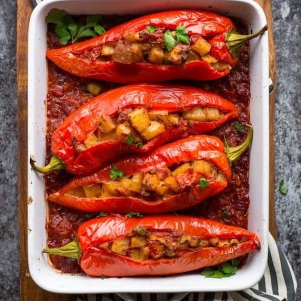Potato and Olive Stuffed Banana Peppers cooked on a cutting board