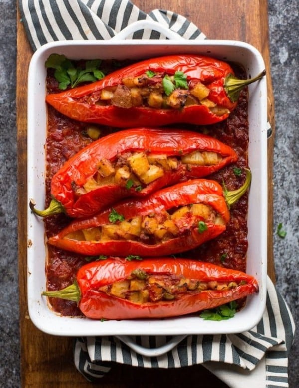 Potato and Olive Stuffed Banana Peppers cooked on a cutting board