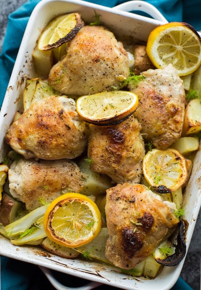 Simple, Roasted Lemon & Fennel Chicken Thighs with potatoes in a baking dish