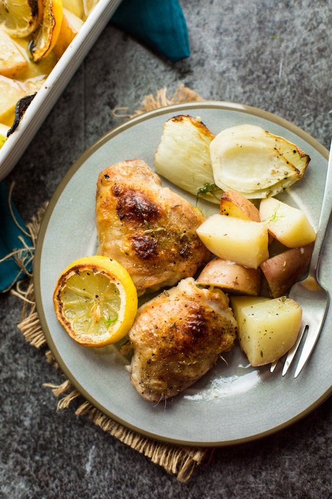 Simple, Roasted Lemon & Fennel Chicken Thighs with potatoes on a plate