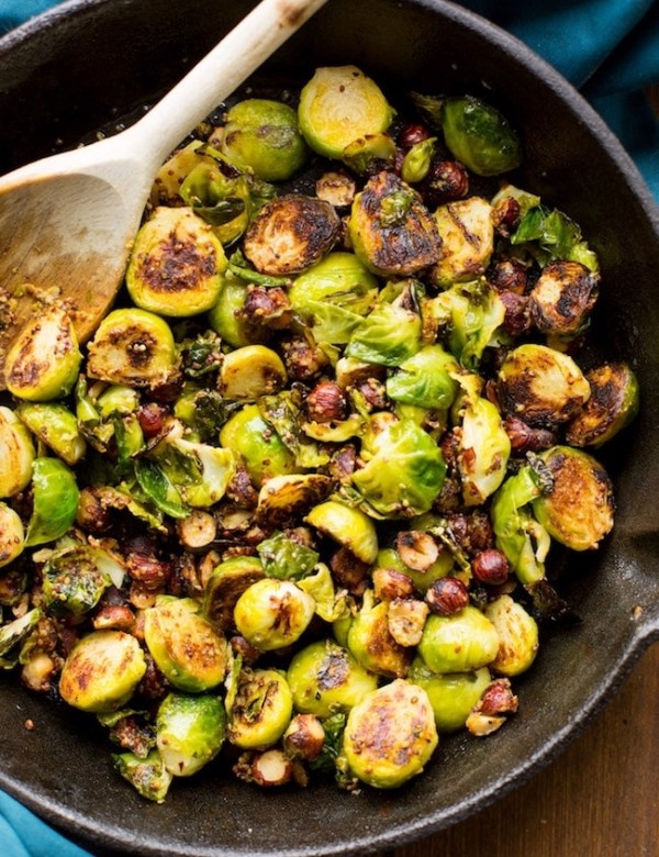 sautéed Brussels sprouts in a cast iron skillet with hazelnuts