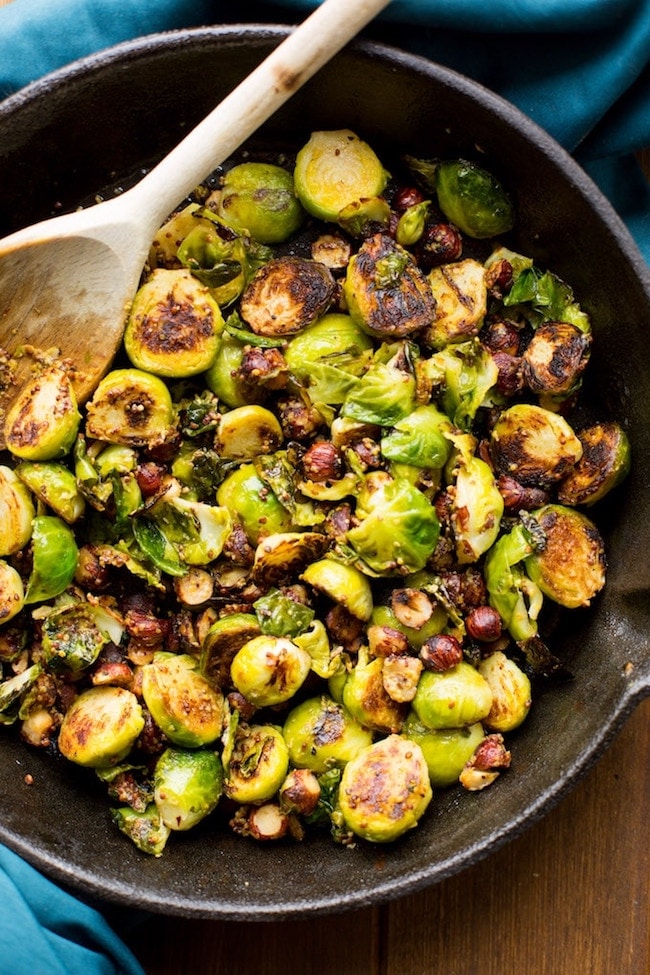  sautéed Brussels sprouts in a cast iron skillet with hazelnuts 