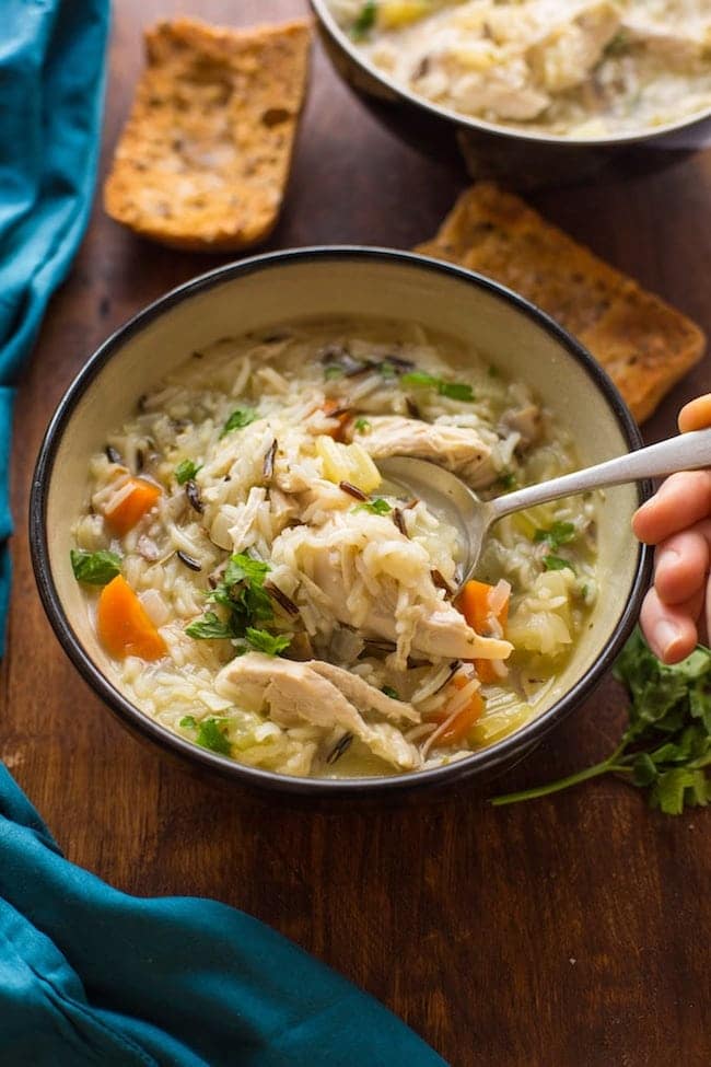 picking up a spoonful of instant pot chicken and wild rice soup 