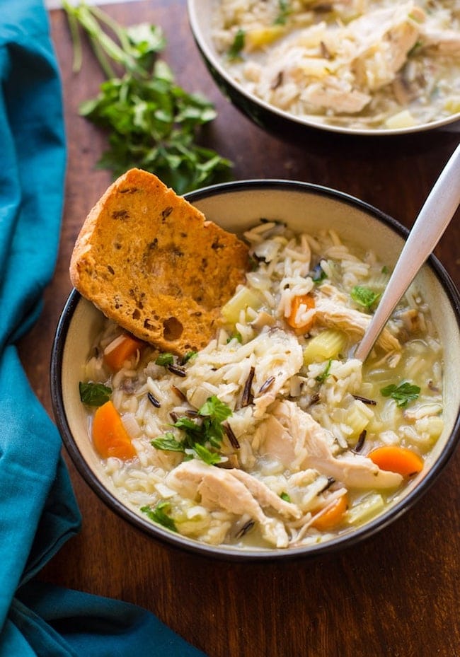 instant pot chicken and wild rice soup with a piece of bread in it