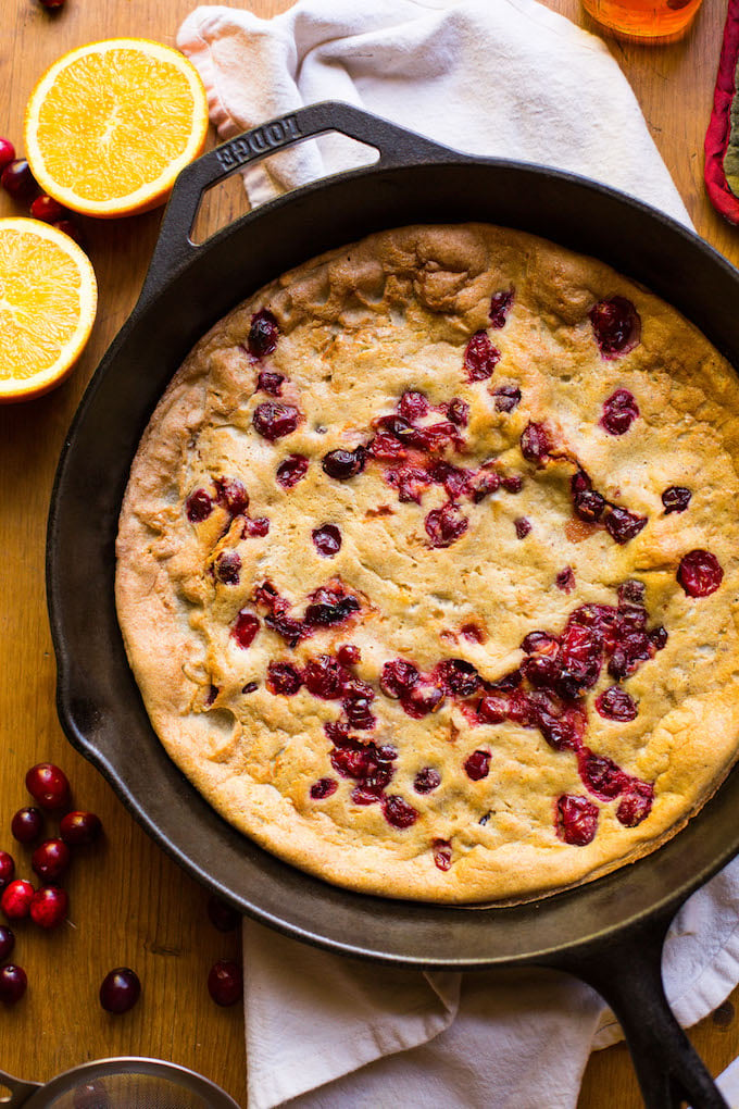 Grain free Cranberry Orange Dutch Baby - sweet, tangy, and perfectly spiced! Perfect for holiday breakfasts & brunches | Dairy Free + Refined Sugar Free