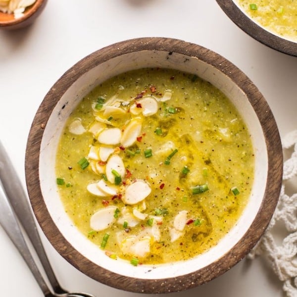 bowl Broccoli Leek Soup topped with sliced almond, chives and red pepper flakes