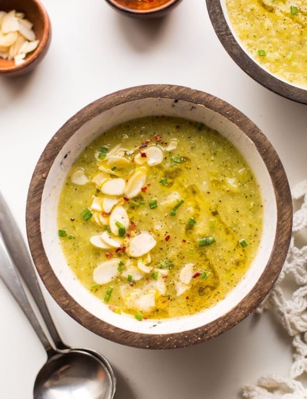 bowl Broccoli Leek Soup topped with sliced almond, chives and red pepper flakes