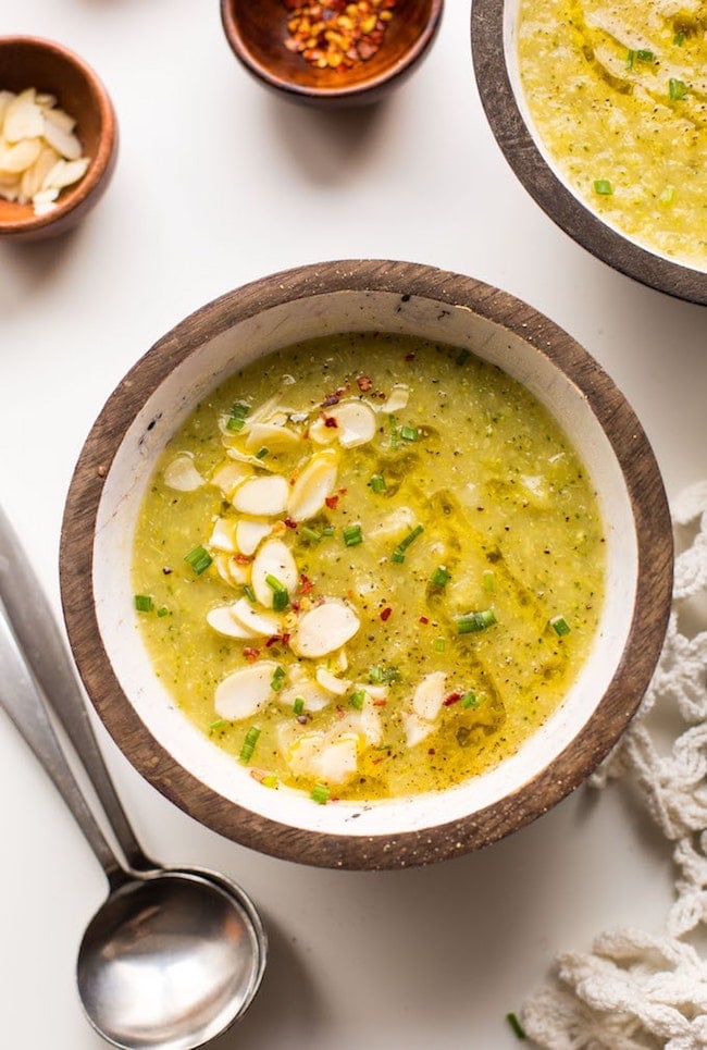 bowl Broccoli Leek Soup topped with sliced almond, chives and red pepper flakes