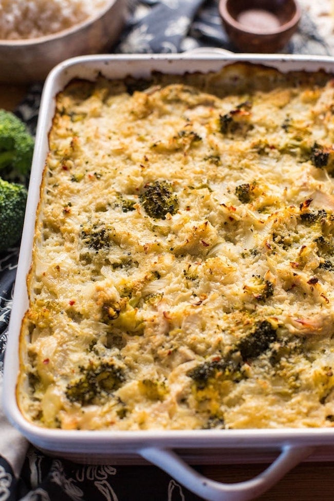 chicken broccoli cauliflower casserole on a wooden table with broccoli up close 