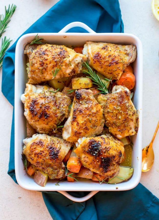 Low FODMAP Maple Mustard Chicken with Rosemary is a roasting pan with potatoes and carrots