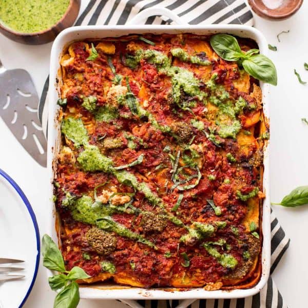 sweet potato lasagna topped with pesto and basil