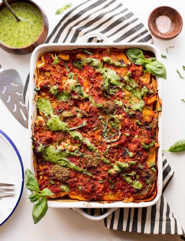 sweet potato lasagna topped with pesto and basil