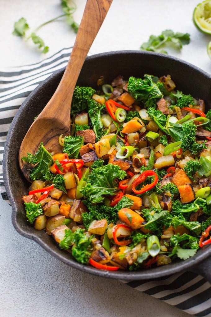 a skillet full of  Kale Potato Breakfast Hash on a kitchen towel