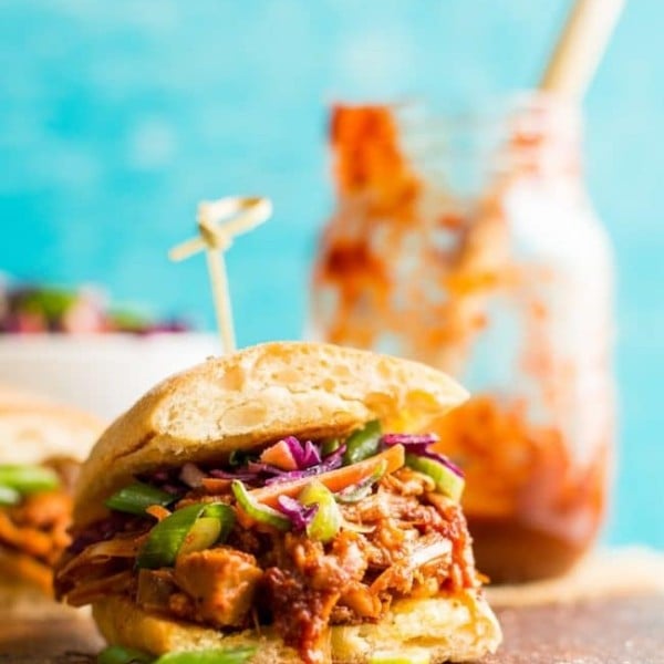 a Vegan BBQ Jackfruit Pulled Pork sandwiches on a wooden cutting board