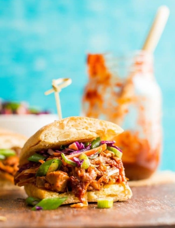 a Vegan BBQ Jackfruit Pulled Pork sandwiches on a wooden cutting board