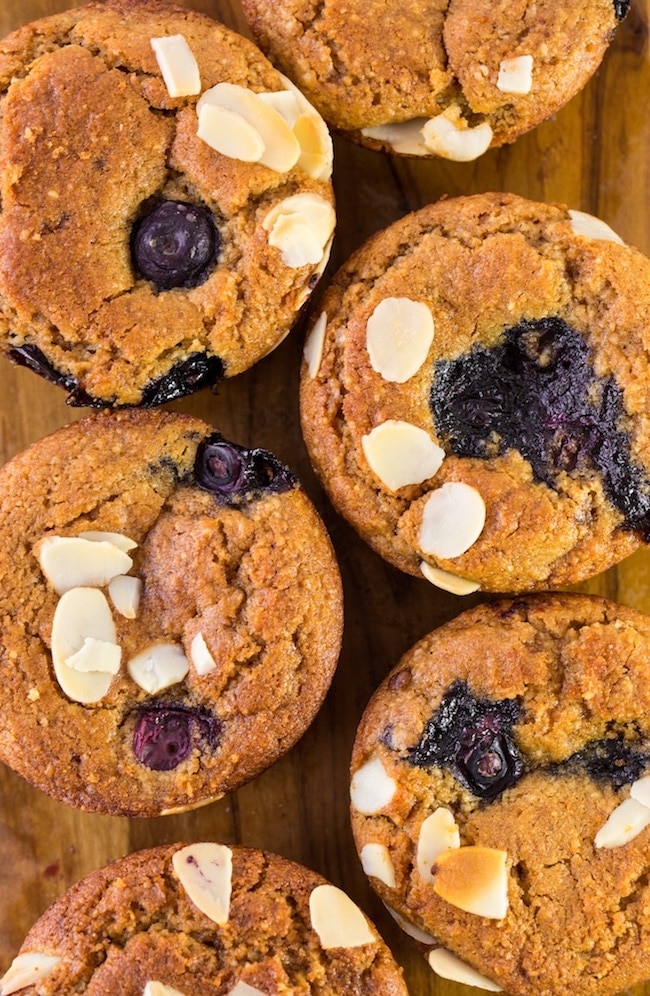 Paleo Vegan Blueberry Muffins up close topped with flaked almonds