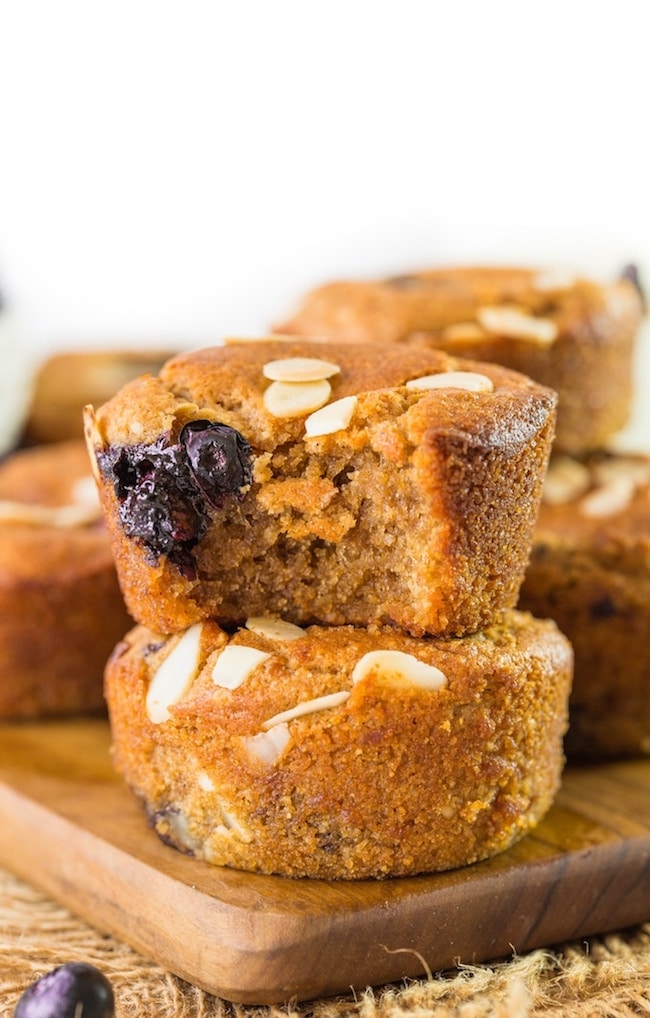 Paleo Vegan Blueberry Muffins stacked - top muffins with a bite taken out