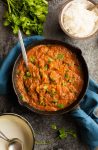 tomato shrimp curry in a cast iron skillet