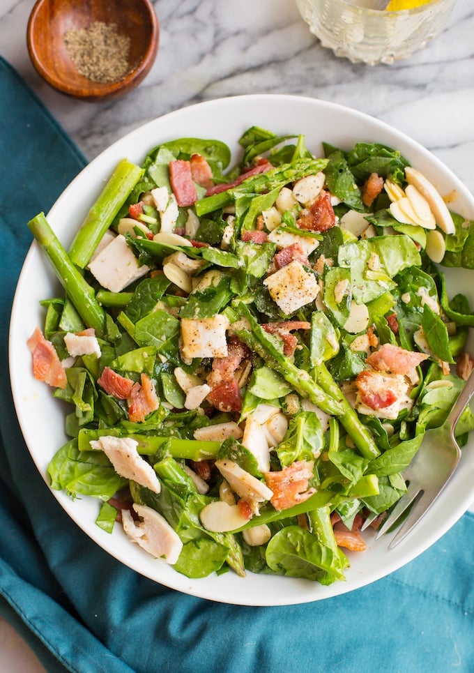 Chicken Bacon Spinach and Asparagus Salad mixed together on a bowl 