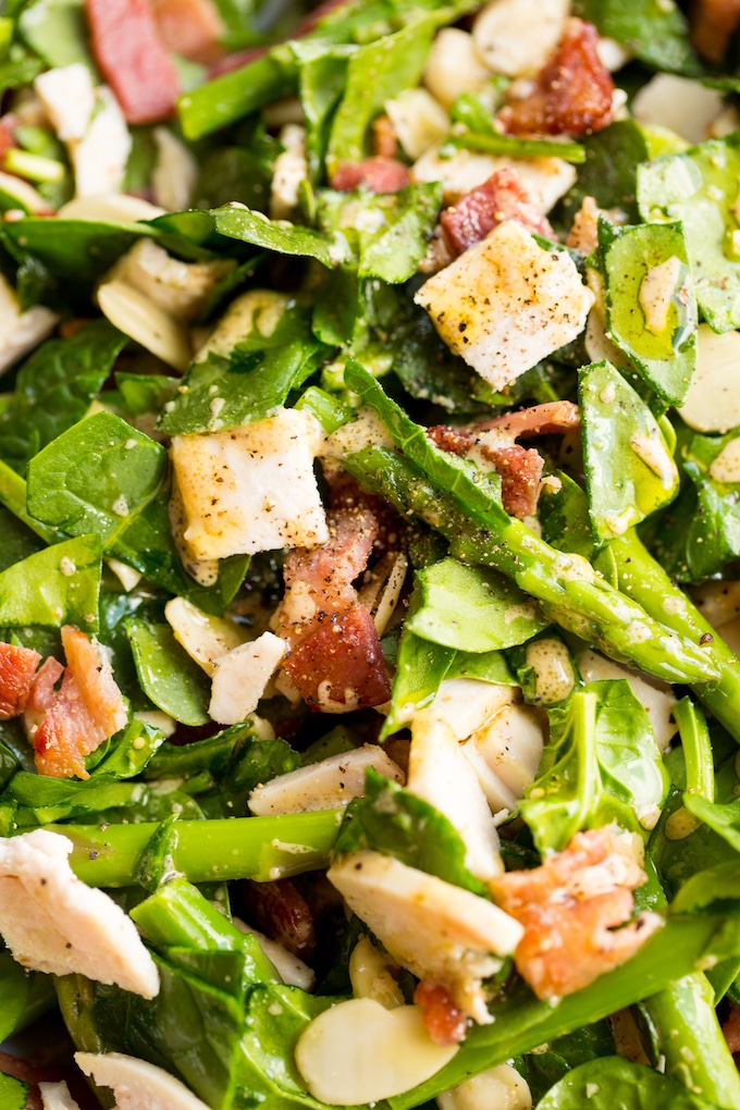 Chicken Bacon Spinach and Asparagus Salad up close and dressed in vinaigrette 