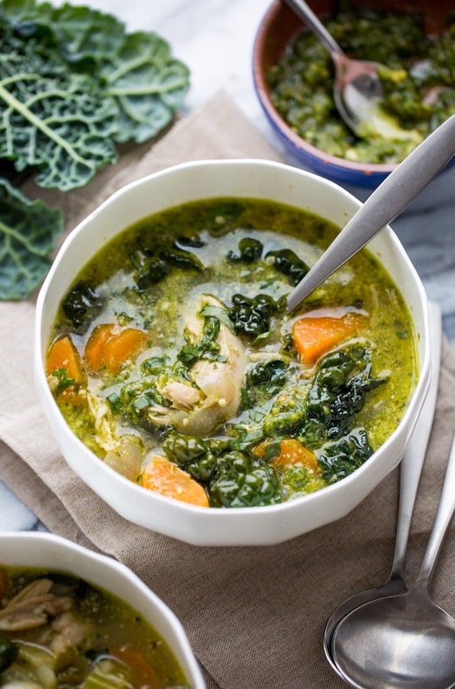 Kale and Chicken Pesto Soup with thick pieces of kale and shredded chicken in a soup bowl