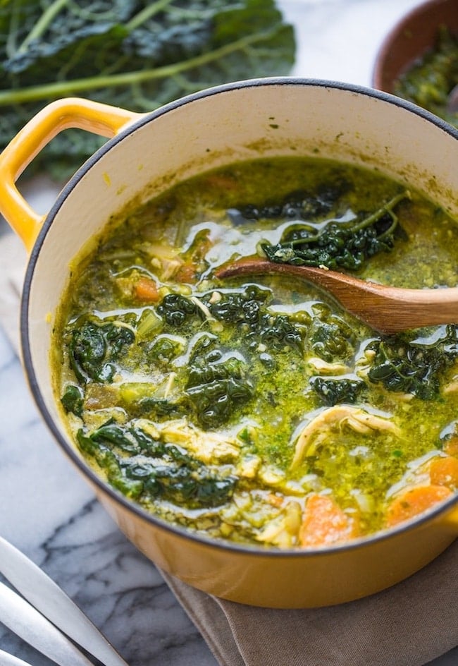 kale & chicken pesto soup in a yellow soup pot